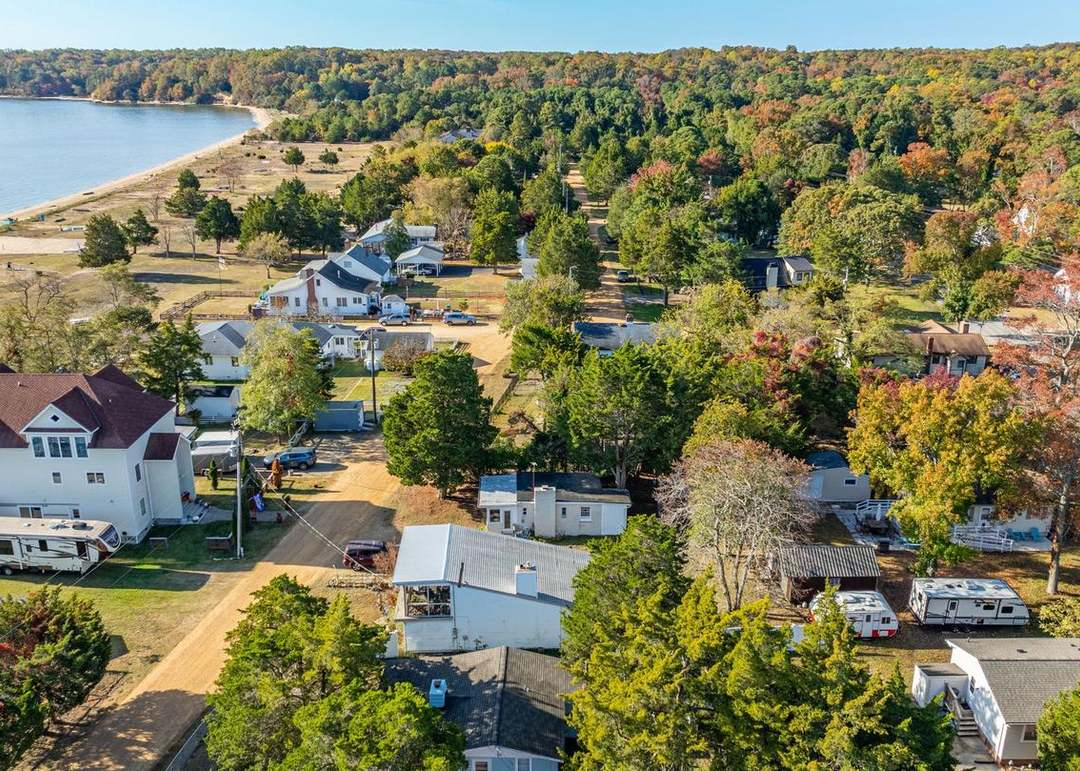 Aerial view of Lusby, Maryland residential neighborhoods near Chesapeake Bay beaches and wooded shoreline